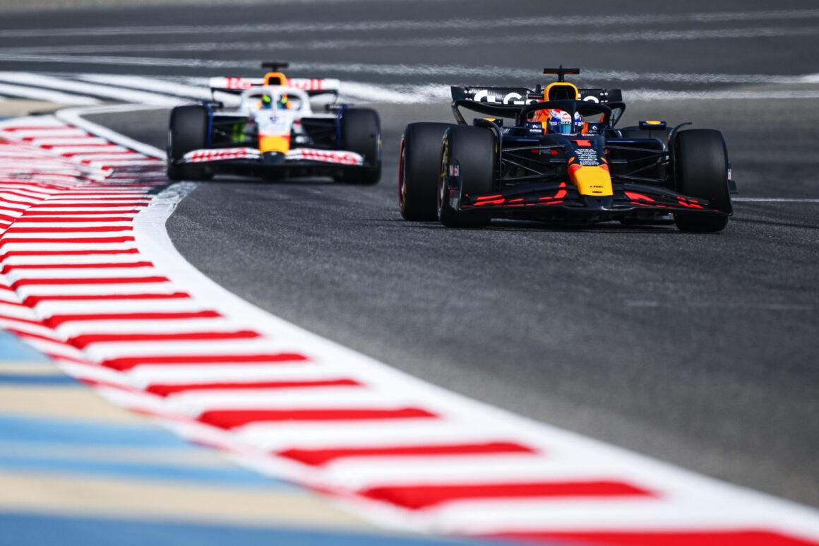 two racing cars driving on a race track